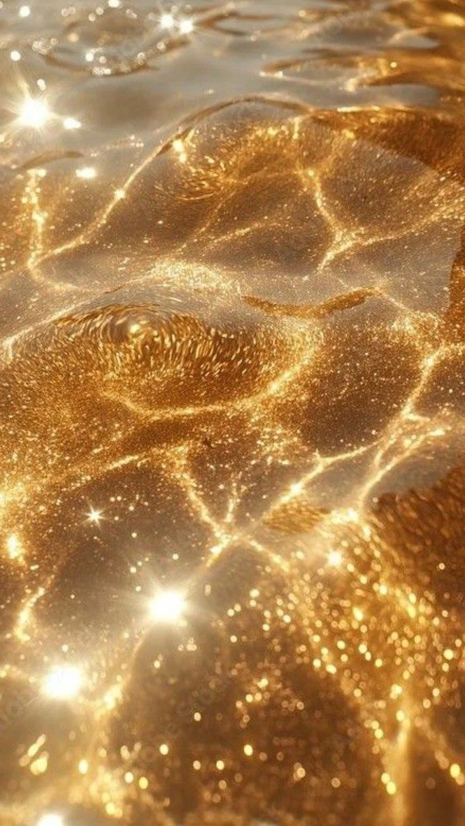 Close-up of a golden, shiny, textured surface resembling a gold nugget or metallic object with sparkling reflections and a glittery appearance.