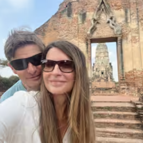 couple standing in front of ancient remains building