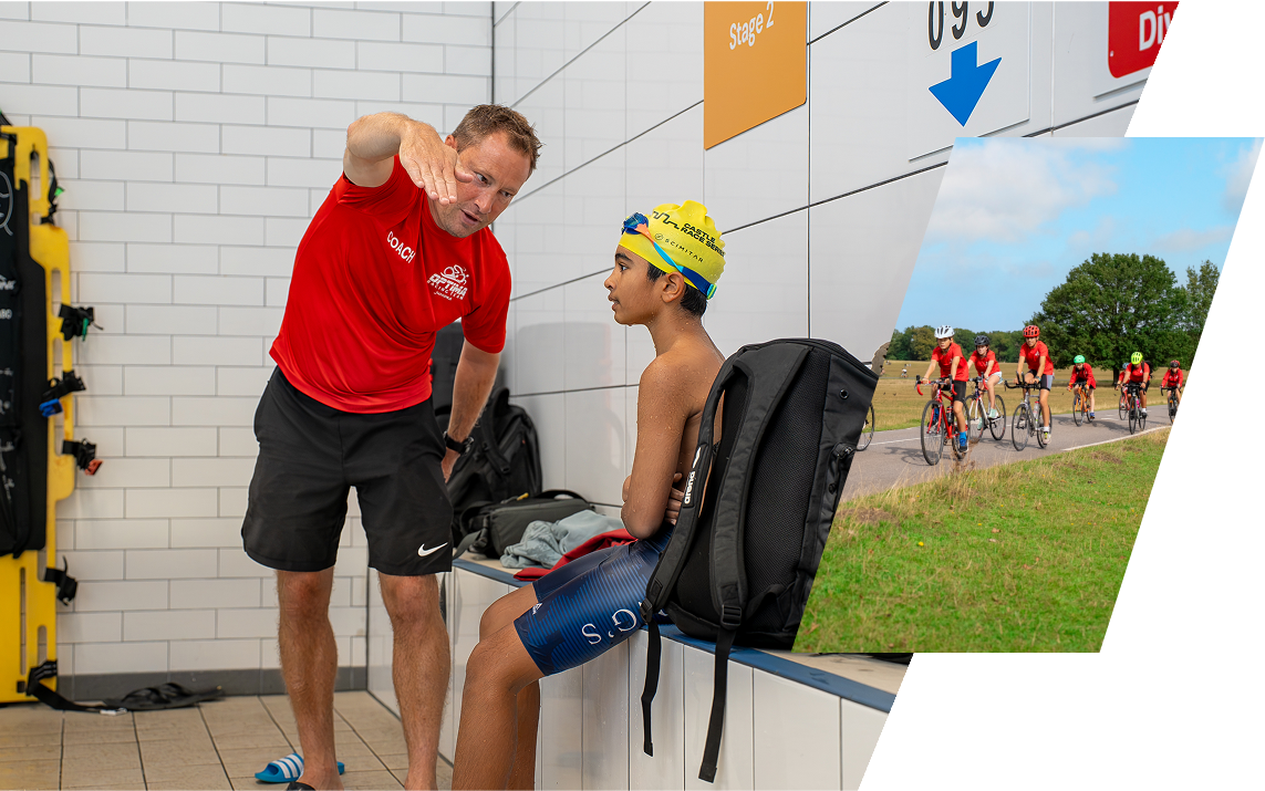 Coach John Lambert giving instructions to a young swimmer sitting on a bench in a pool area, with a group of people cycling outdoors in the background.