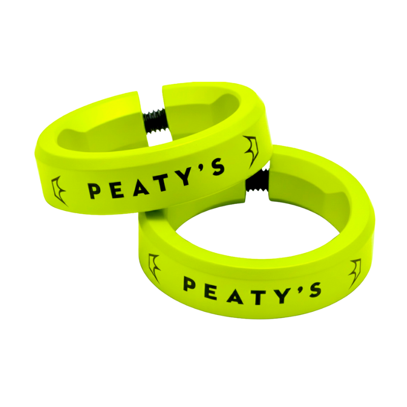 Two bright yellow silicone rings with the text 'PEATY'S' and small bat illustrations in black, connected by a black screw clasp.