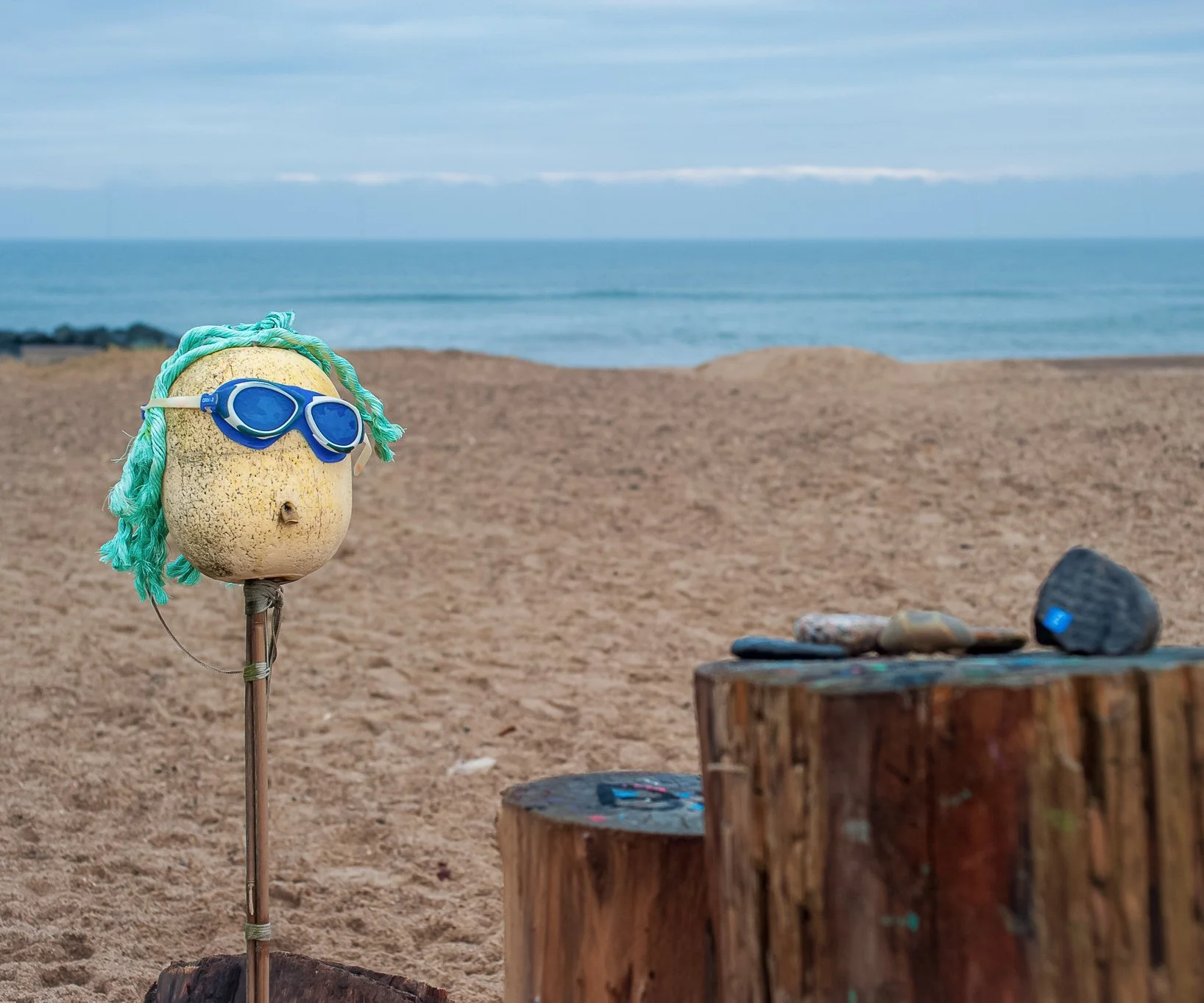 Beach installation made from found objects near the shoreline.