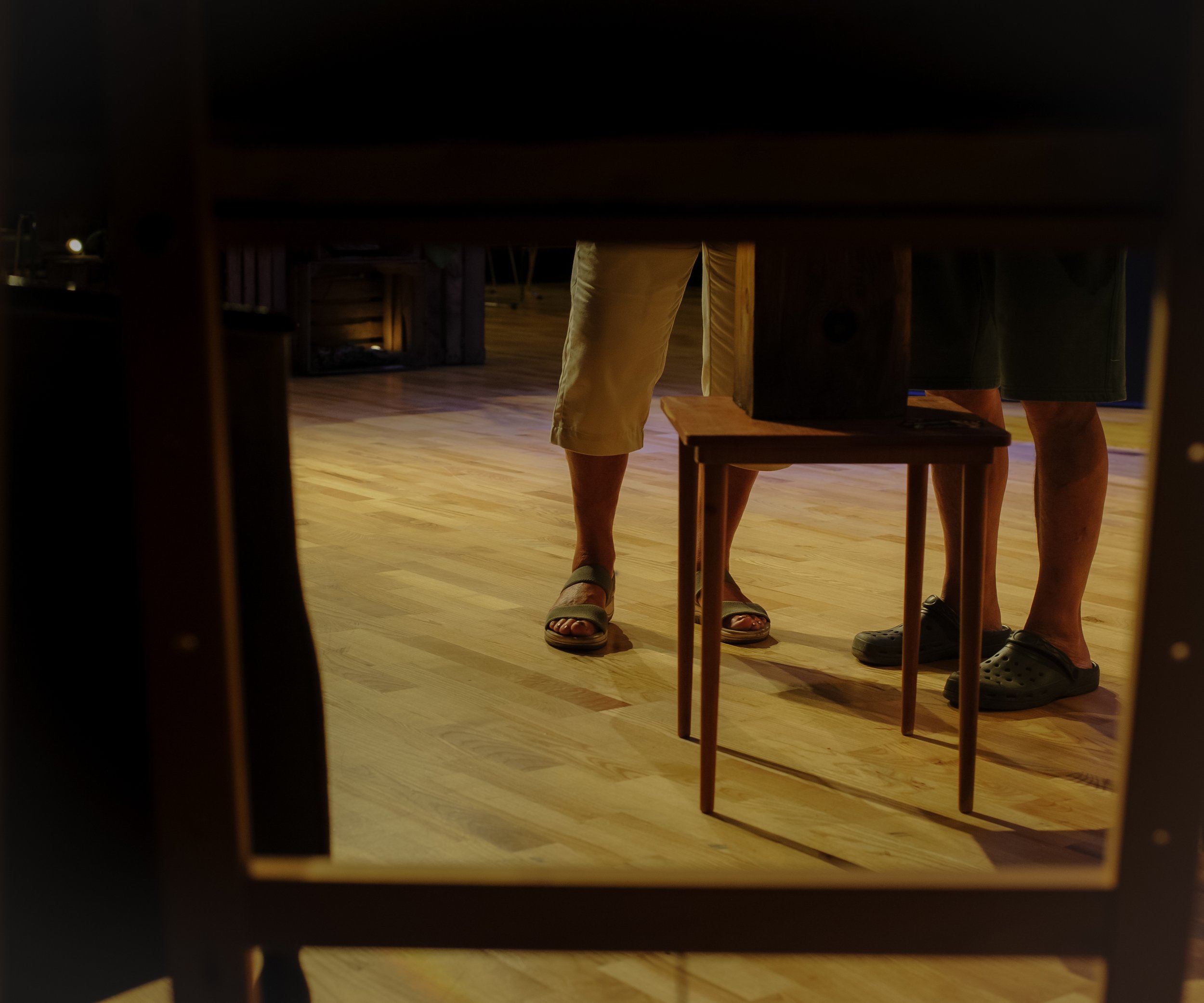 People standing around a table, viewed from below.
