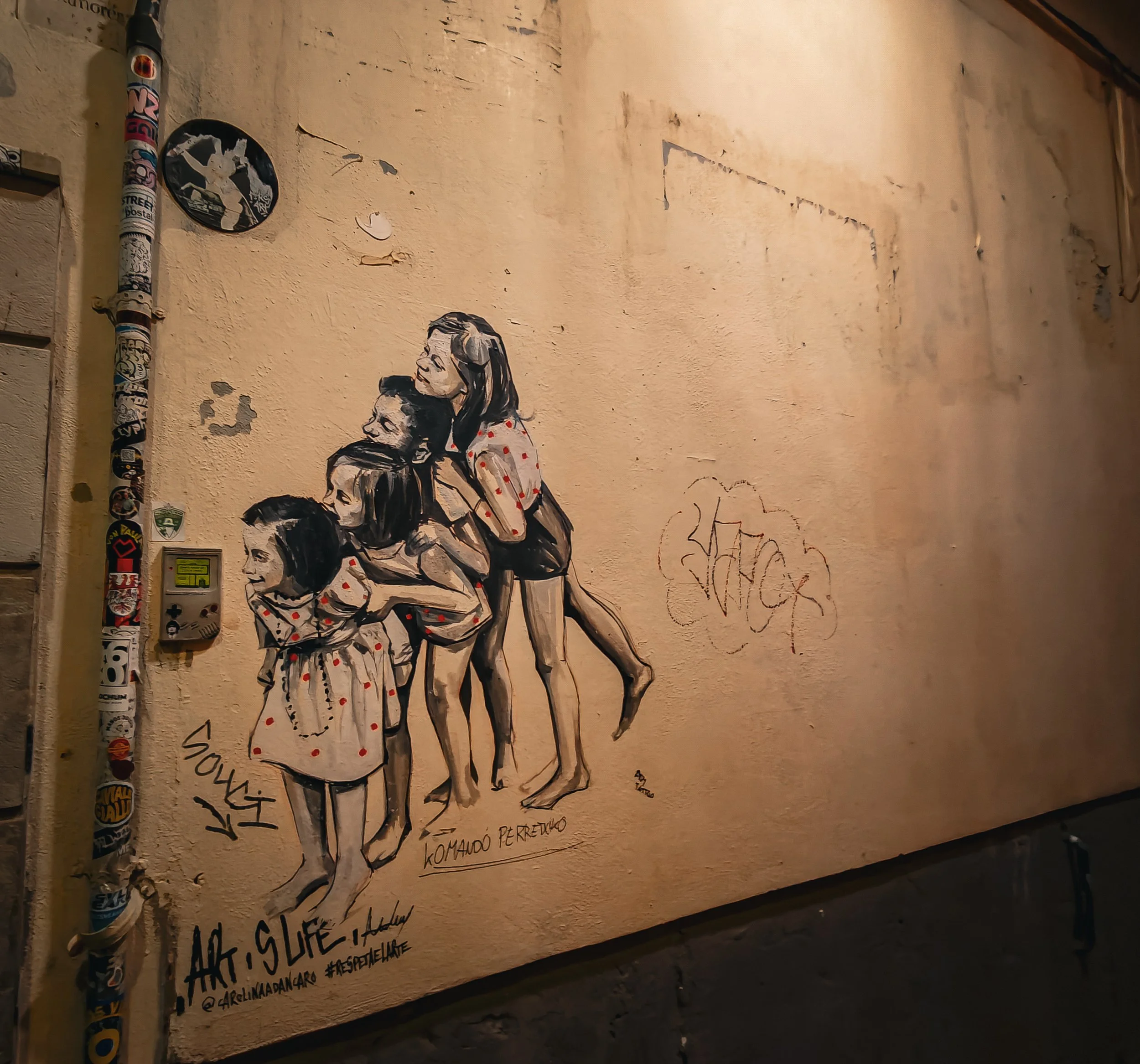 Mural of a group of people on a worn wall.