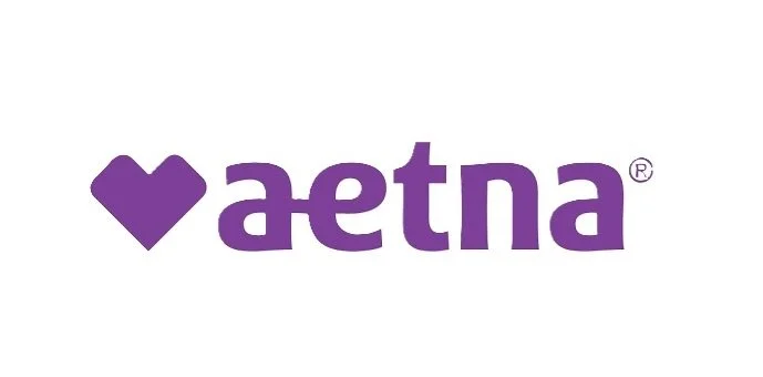 A logo with a purple heart shape followed by the word 'aetna' in purple letters on a white background.