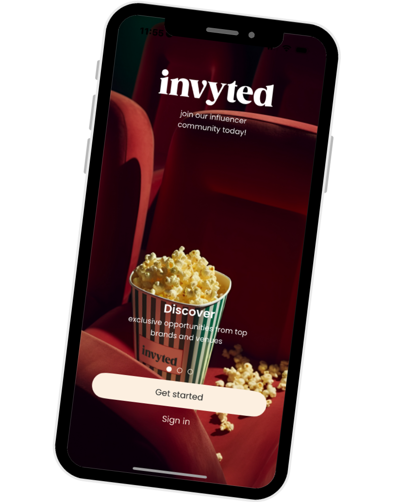 Mobile phone displaying the Invited app welcome screen with a background image of red theater seats and a bucket of popcorn, inviting users to discover exclusive opportunities for influencer branding.