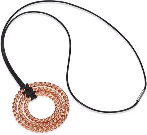 A picture of a pendant with 3 copper tensored rings