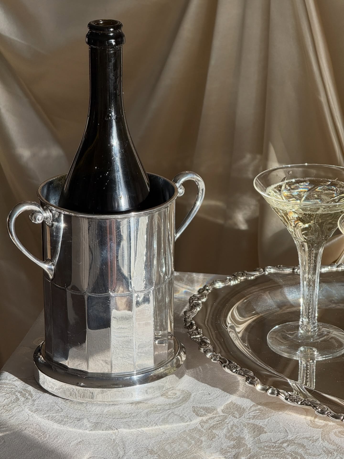 This early 20th century silver-plated bottle holder carries the elegance of gatherings past. Moments marked slowly with something special shared between a few. Its sculptural form feels both timeless and ceremonial, elevating the simple act of pourin