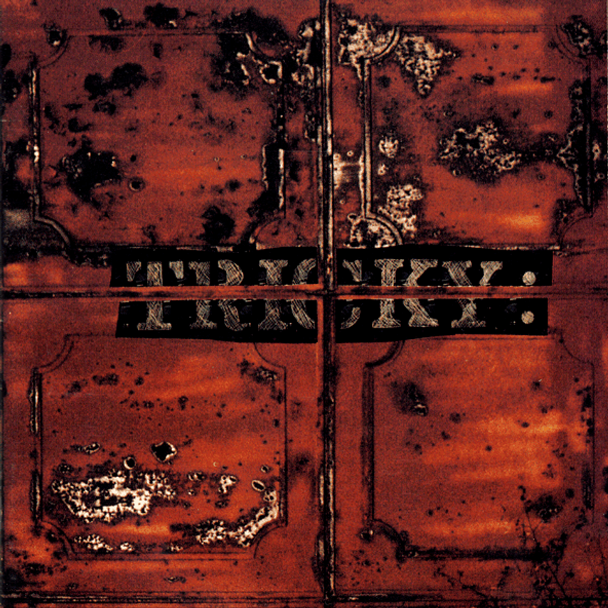 Rusty, weathered wooden surface with faded black lettering that reads "FUD YUX"," likely part of an old sign or label.
