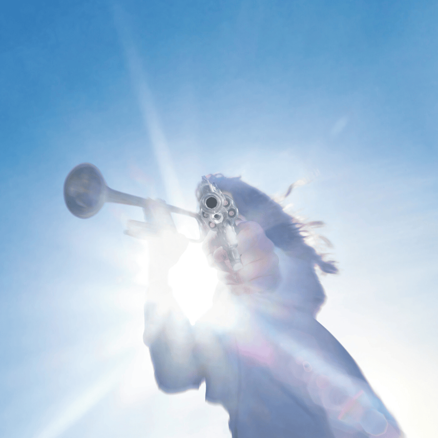 Person holding a gun pointed at the camera, with bright sunlight behind them and a clear blue sky.