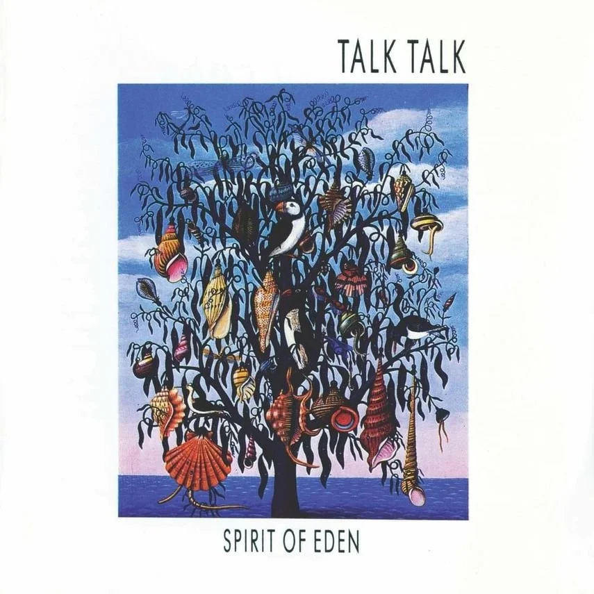 An illustration of a tree with black branches and no leaves, against a blue sky. The tree is adorned with various colorful shells and sea creatures, with the ocean in the background. The text above reads "TALK TALK" and below "SPIRIT OF EDEN."