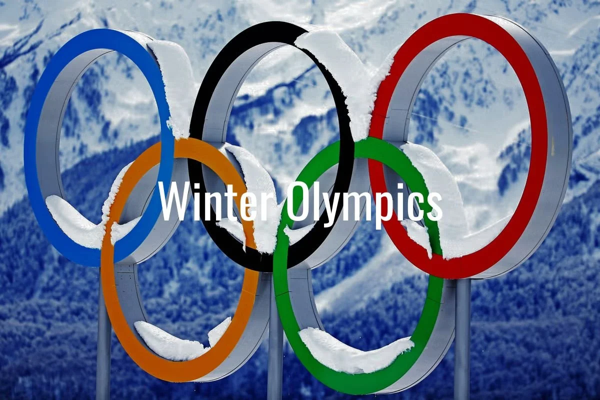 Olympic rings with snow on them and a snowy mountain background, overlaid with the text "Winter Olympics."