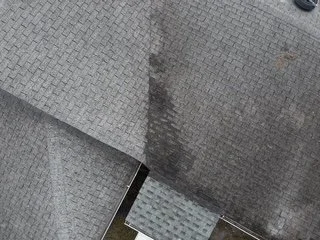 Close-up of a metallic elevator door with a textured surface and a small section of a tiled floor visible at the bottom.