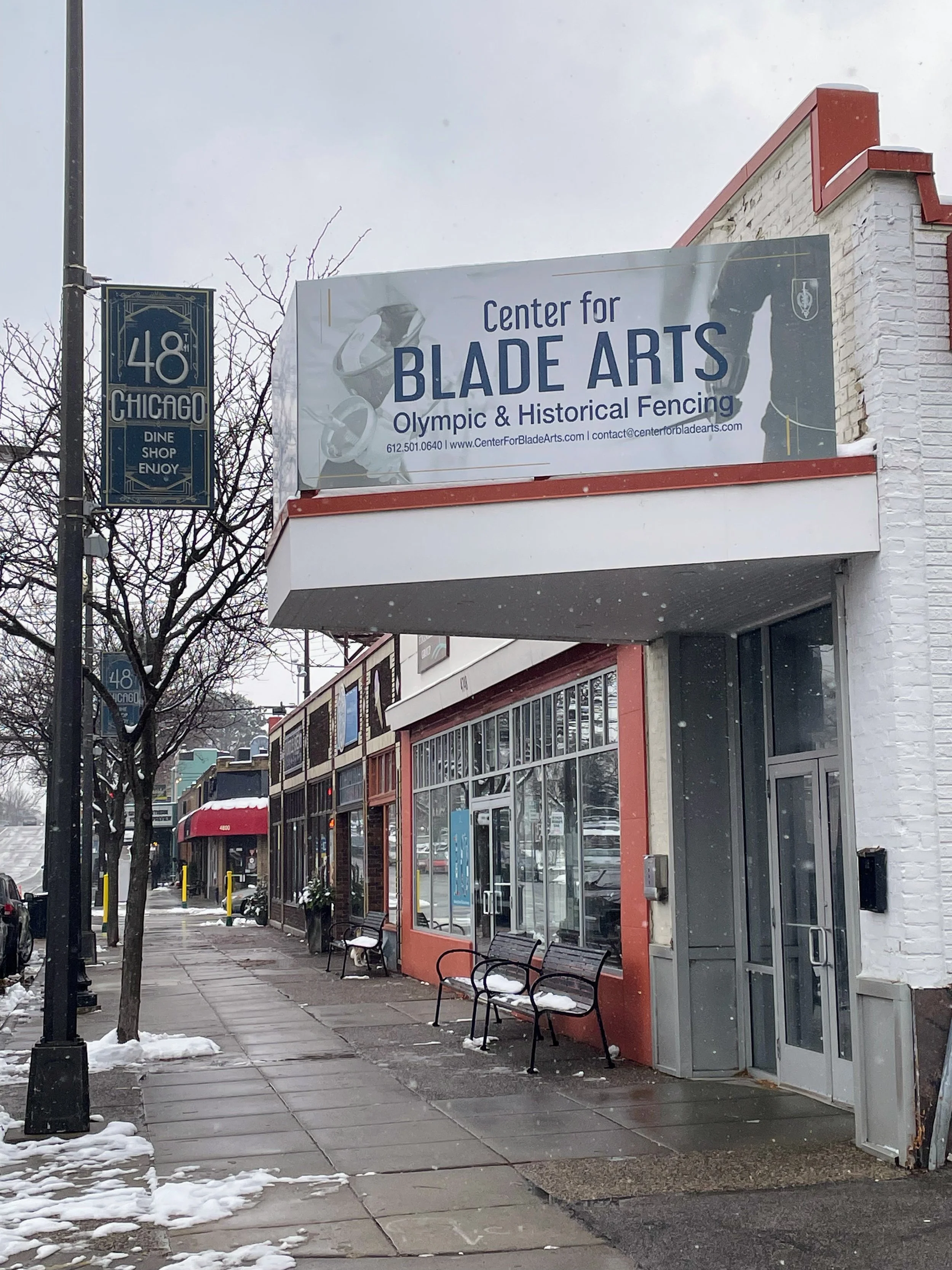 Looking down the block from just past the clinic at all of the shops on the west side of the 48th and Chicago node including the Center for Blade Arts. Photo taken by Brit Anbacht.