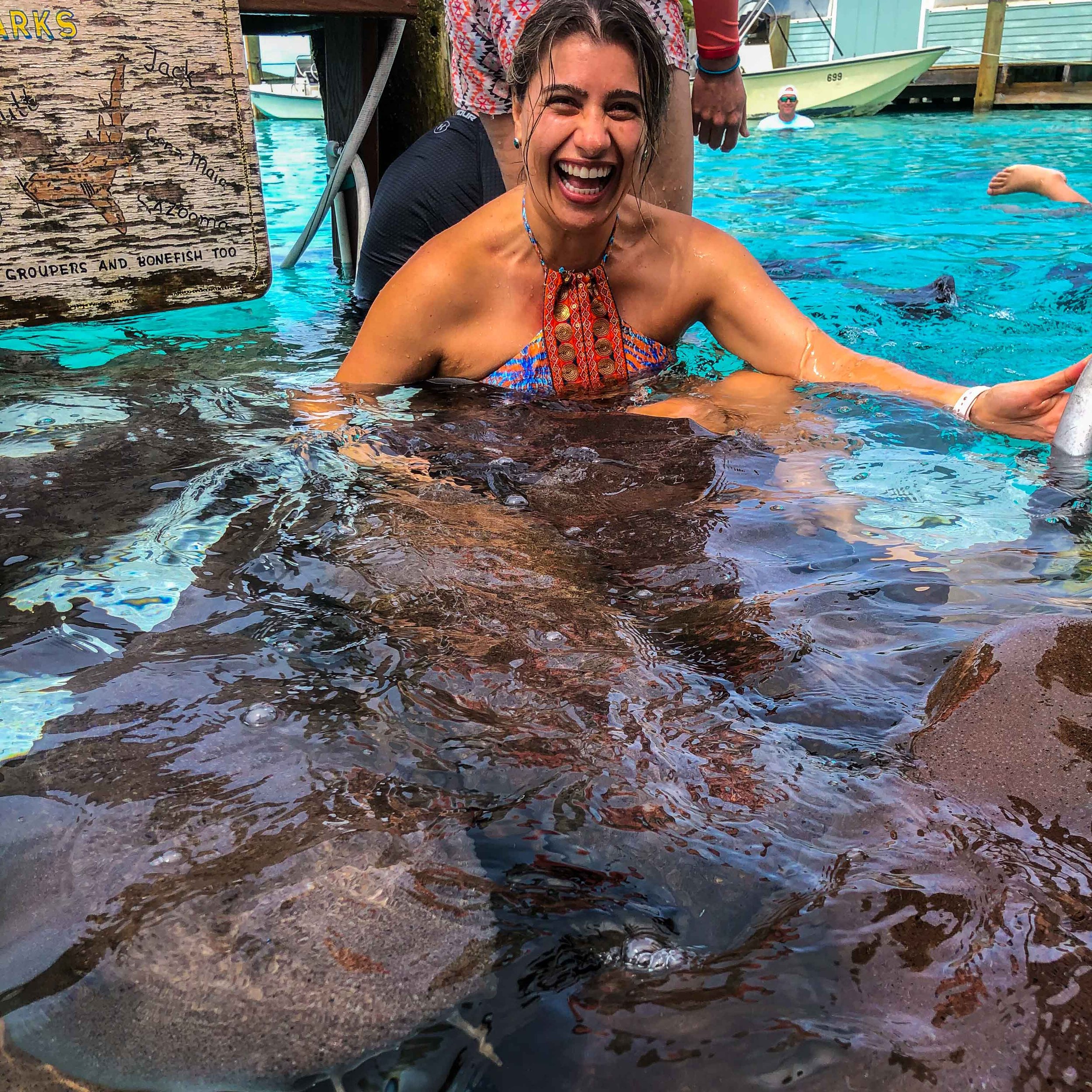 a happy woman surrounded by sharks