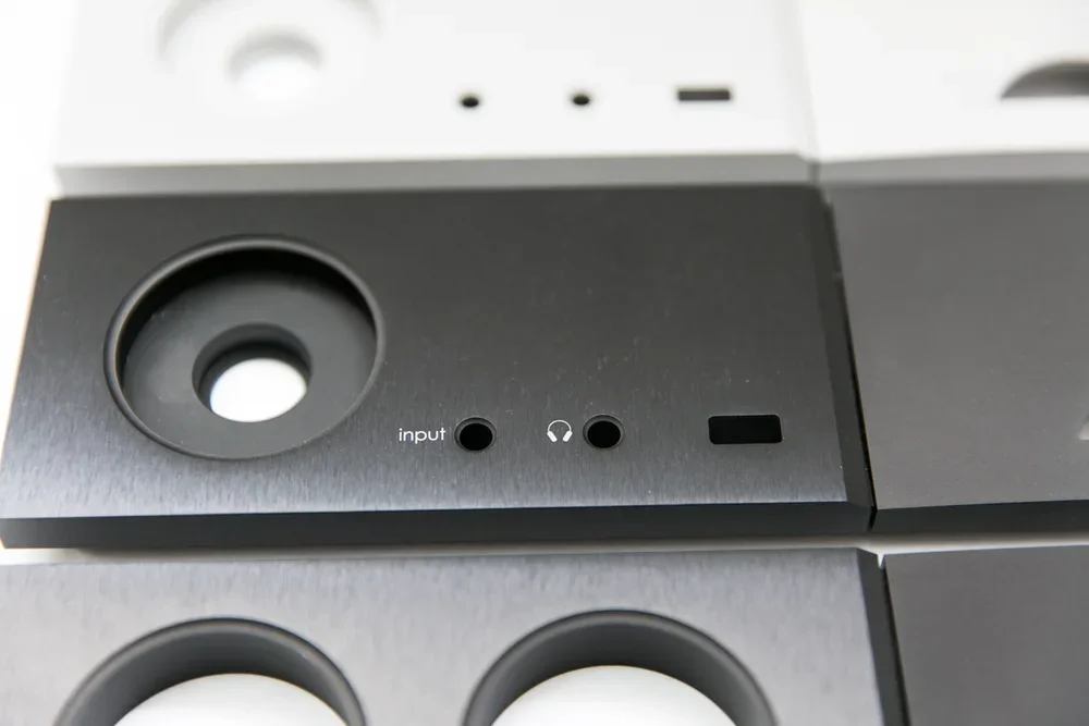 Close-up of a speaker with input and headphone jack ports.
