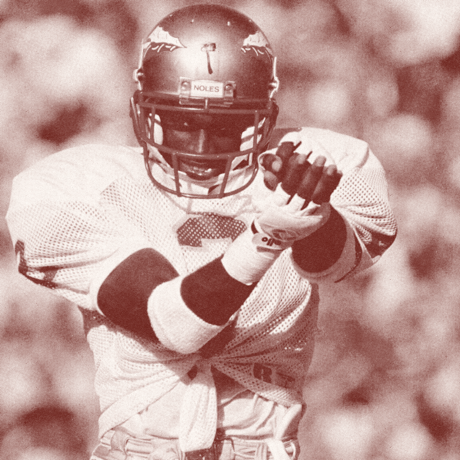 An American football player in uniform with a helmet, preparing to throw a football.