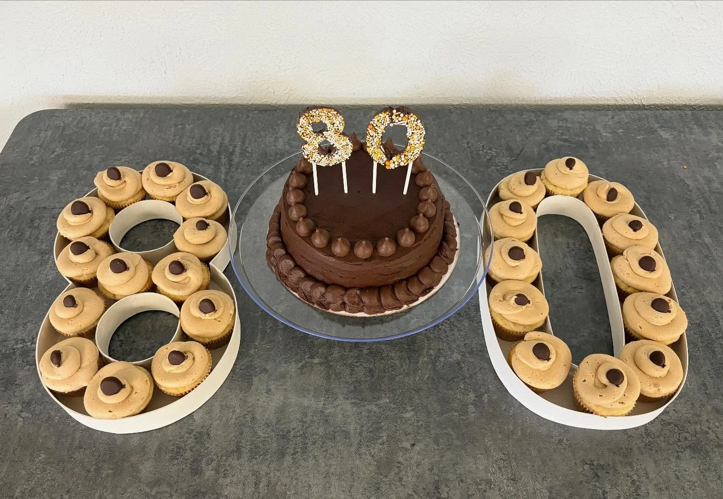 I made a cake and cupcakes for my pap&rsquo;s 80th surprise party! It was a chocolate cake with chocolate frosting, and the cupcakes were vanilla with peanut butter frosting!🍫🎉