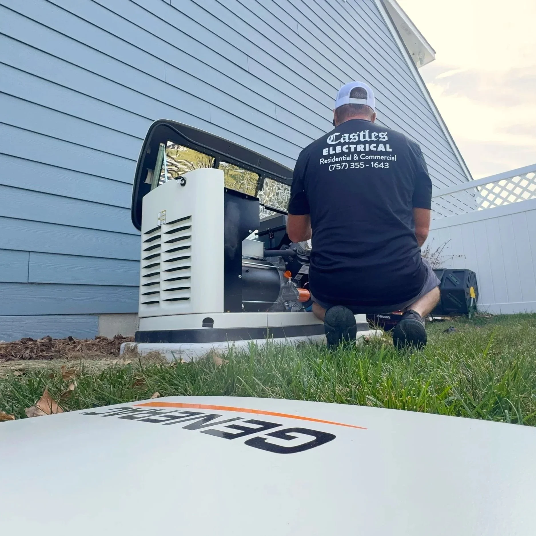 A hand carefully wrapping black electrical tape around a frayed wire to provide temporary insulation and prevent electrical shorts.