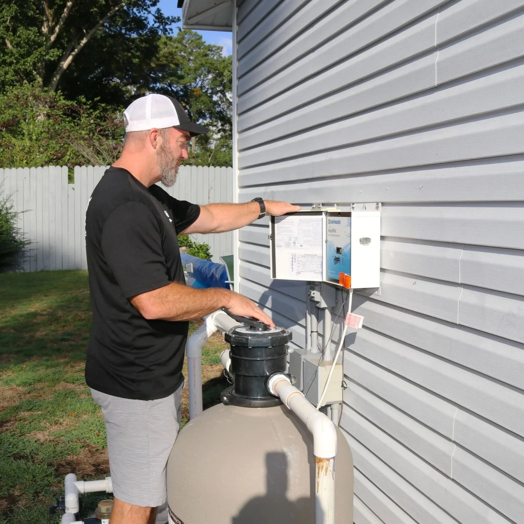 Yellow electrical circuit tester plugged into a home outlet, displaying two lights indicating a dangerous open ground.
