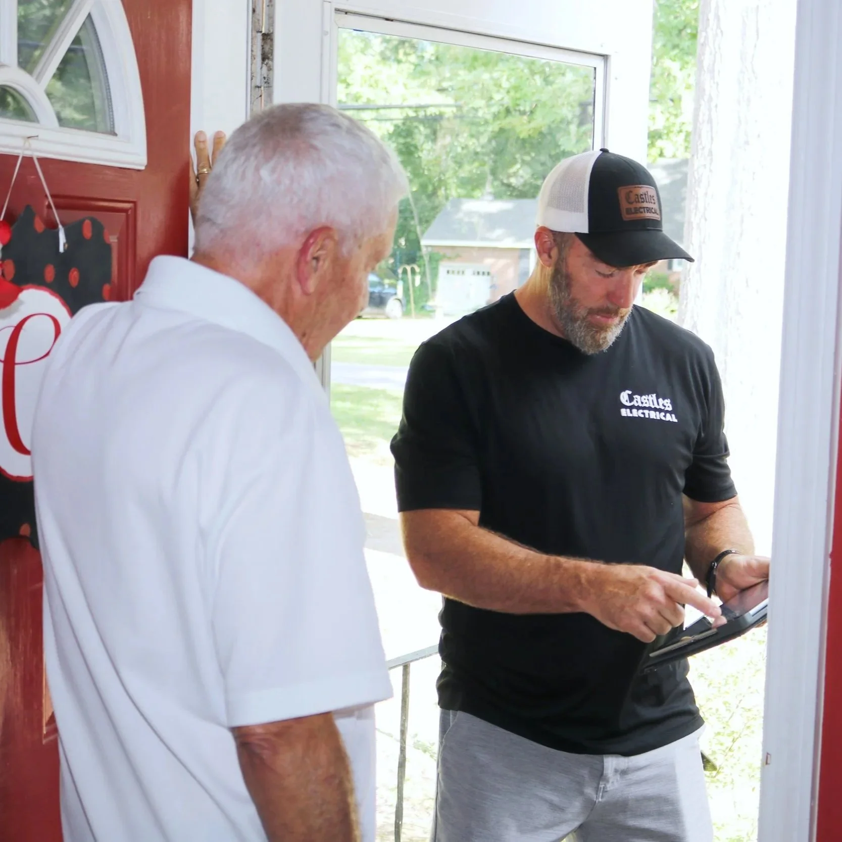 A professional electrician inspects a residential circuit breaker panel at night using a flashlight to diagnose frequent power tripping issues.