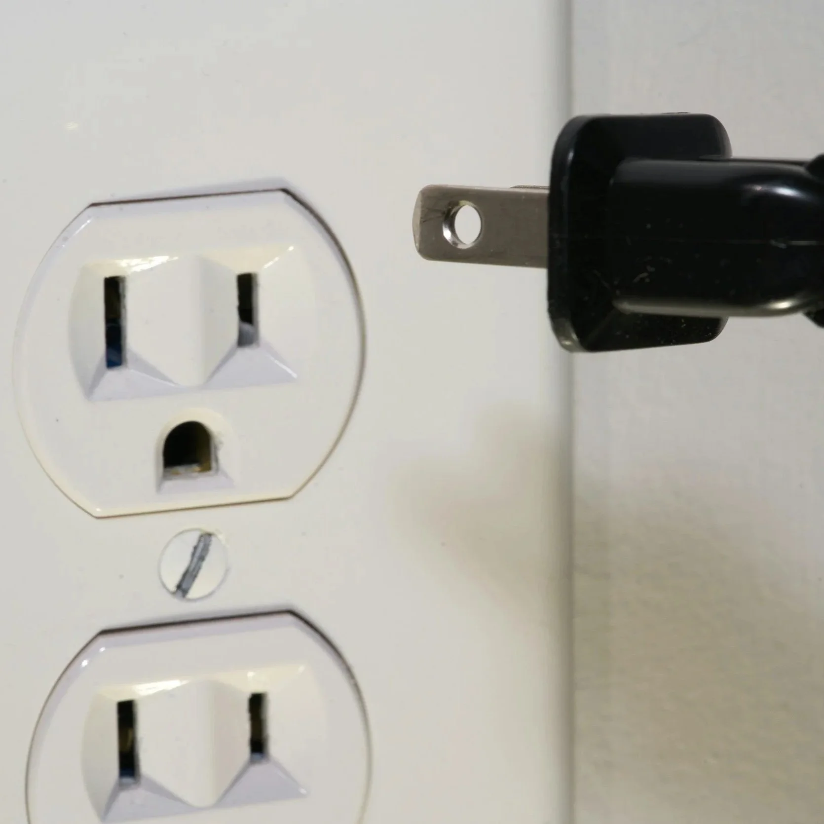 Standard electrical outlet with a circuit tester showing "Hot/Neutral Reverse" lights, highlighting dangerous wiring errors in Virginia Beach homes.