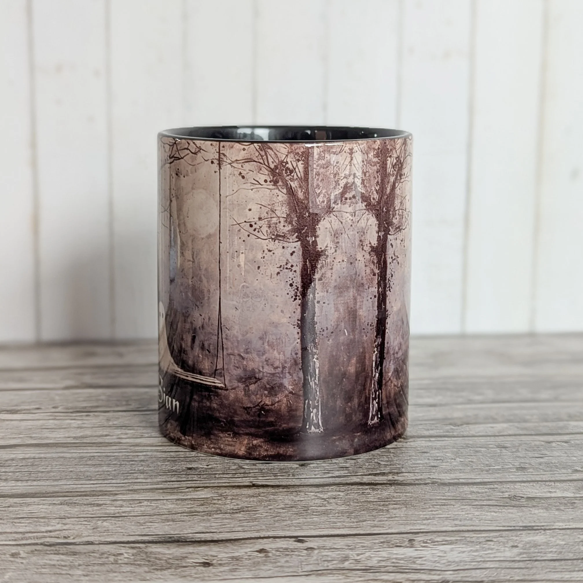 Personalised ceramic mug with haunted house Halloween design, optional custom name, black handle and interior.