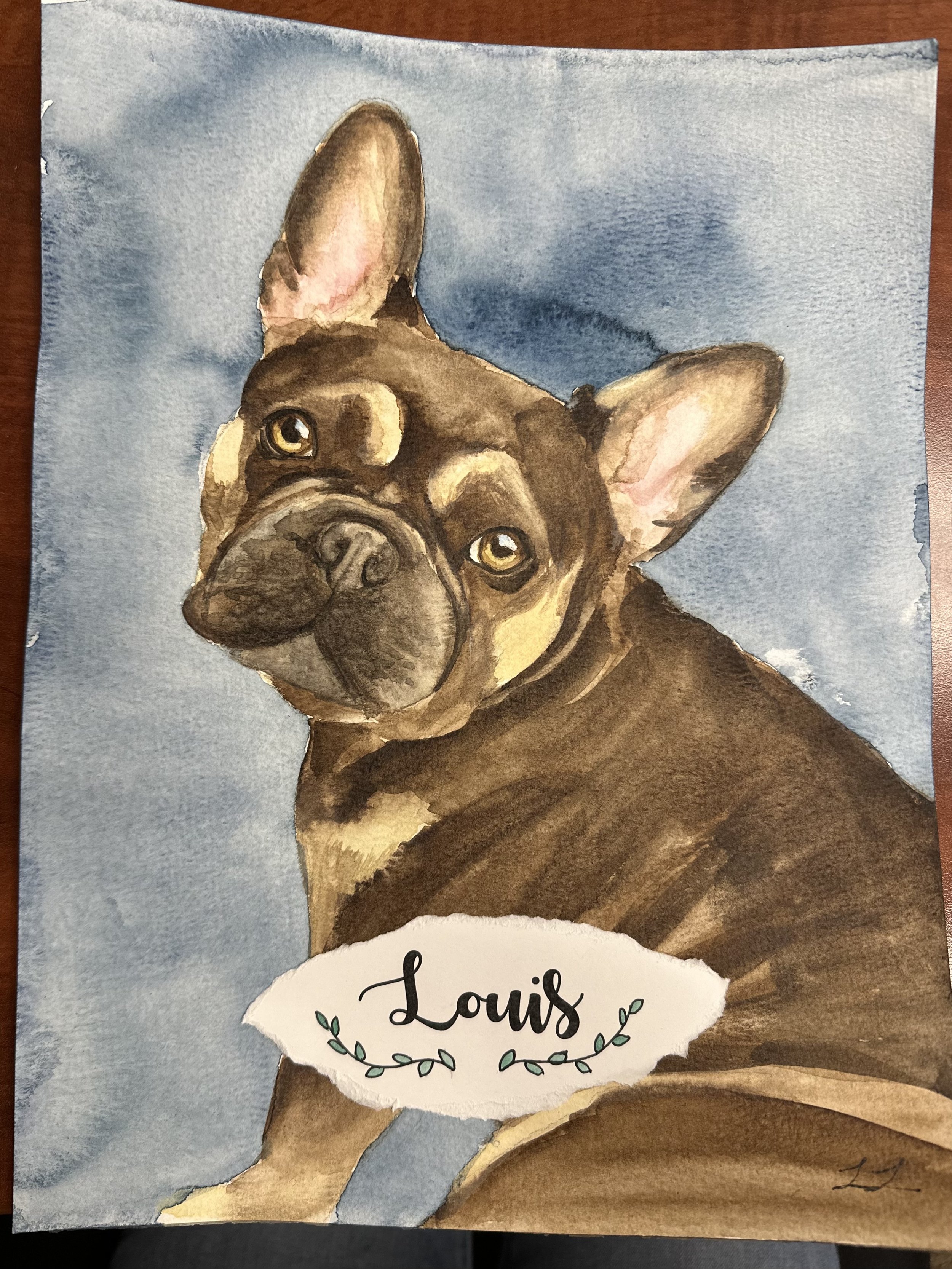 Watercolor painting of a French Bulldog's face with a blue background and a torn paper section at the bottom that says 'Louis' with decorative leaves.