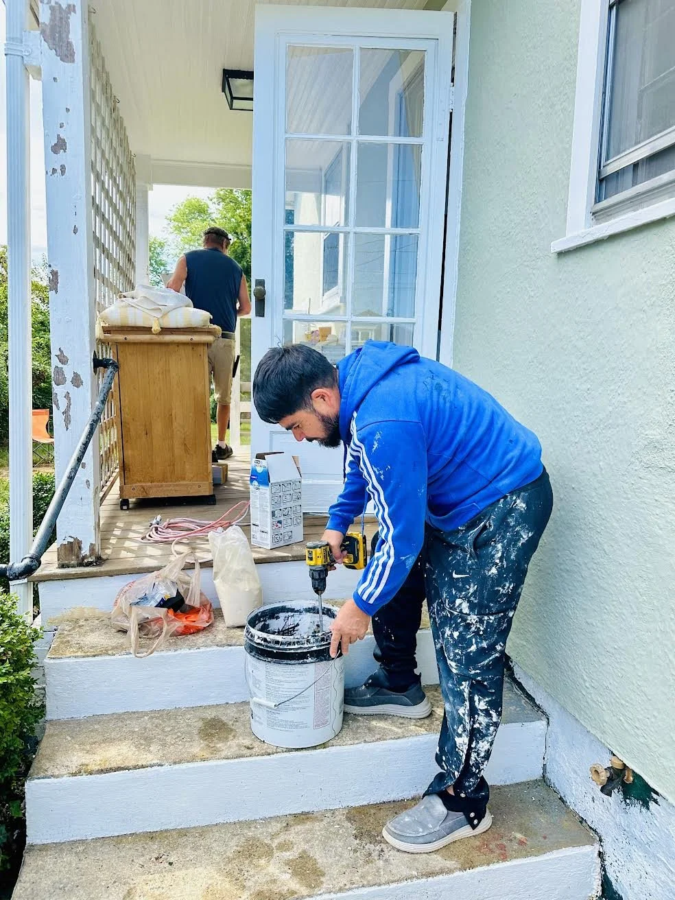Manny preparing cement in bucket