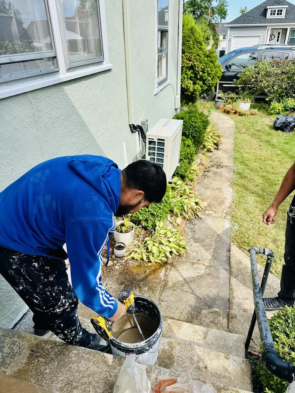 Manny stirring cement in bucket