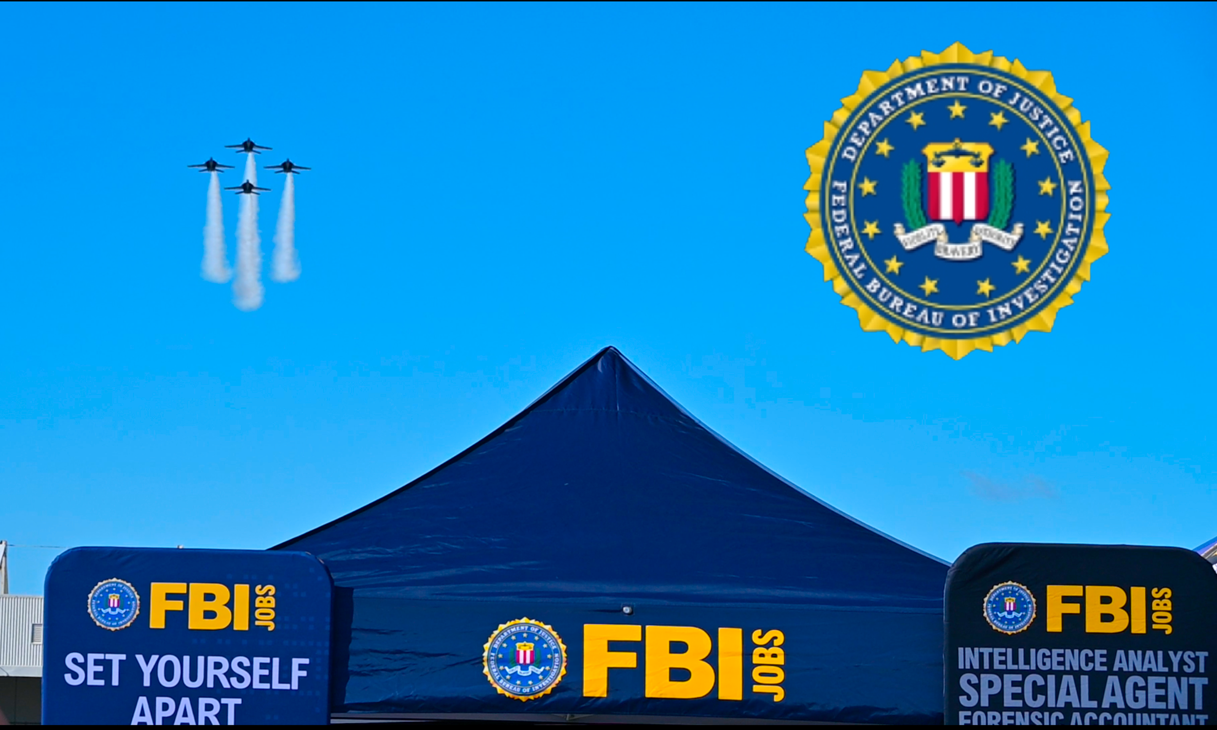 FBI Jobs tent at an outdoor event with a blue canopy displaying the FBI logo and the words "FBI Jobs". Signs on either side promote FBI careers as a Special Agent and Forensic Accountant. In the sky, six fighter jets fly in a formation, leaving white