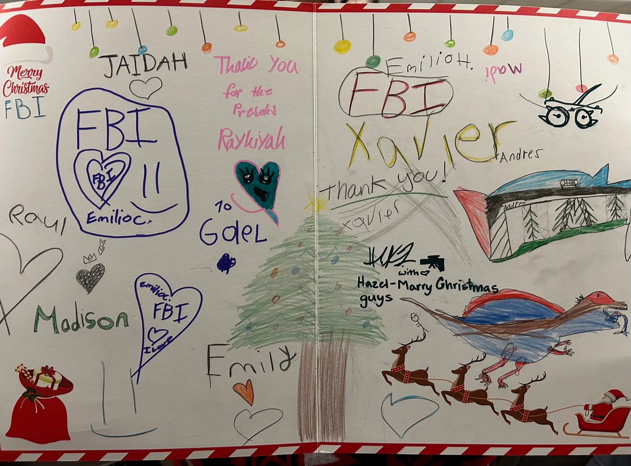 Decorative Christmas greeting card with colorful drawings and handwritten messages. Features a decorated Christmas tree at the center, surrounded by doodles of reindeer, a sleigh, a snow scene, hearts, and gifts. Handwritten notes express holiday wis