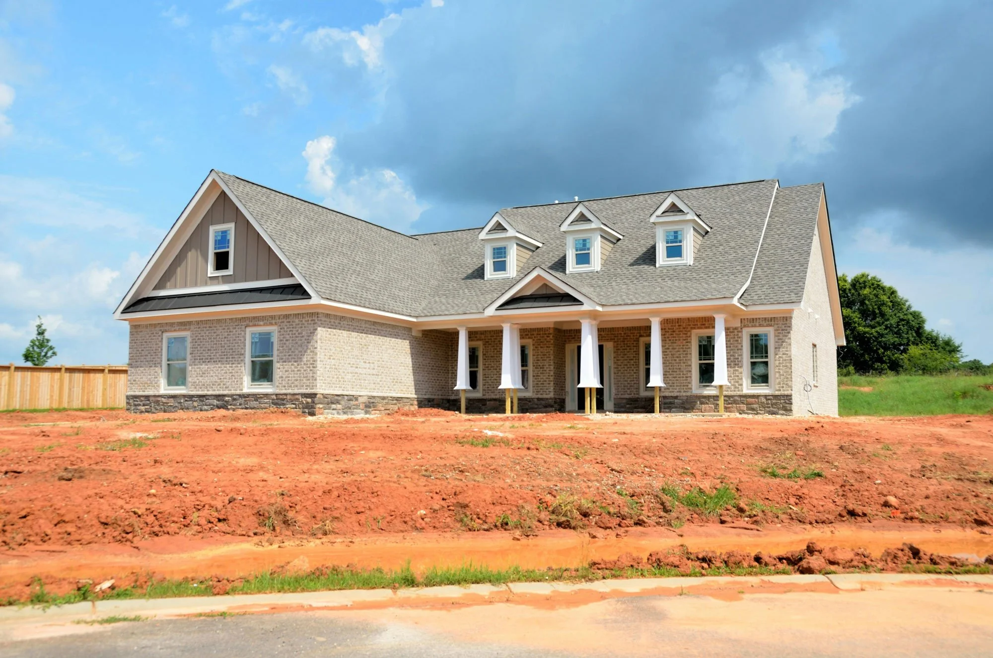 Original Property Photograph | Construction-stage source image before landscaping, cleanup, architectural refinement, and final image finishing.