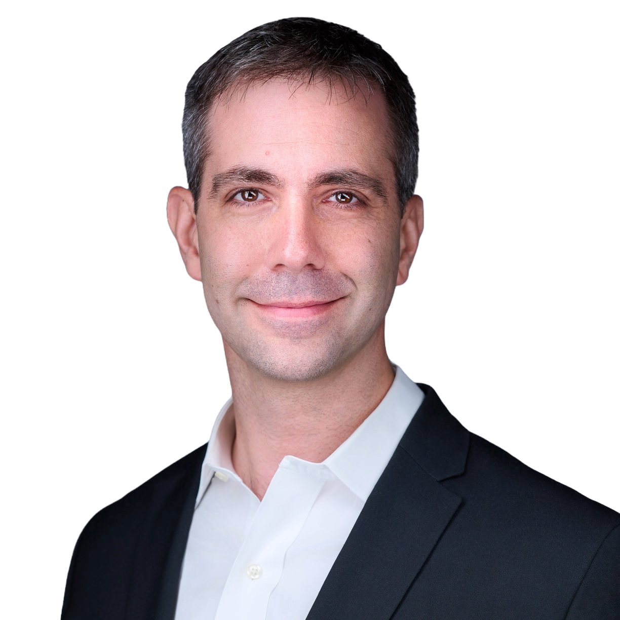 A professional headshot of a man with short brown hair, wearing a black suit jacket and white dress shirt, smiling against a plain background.