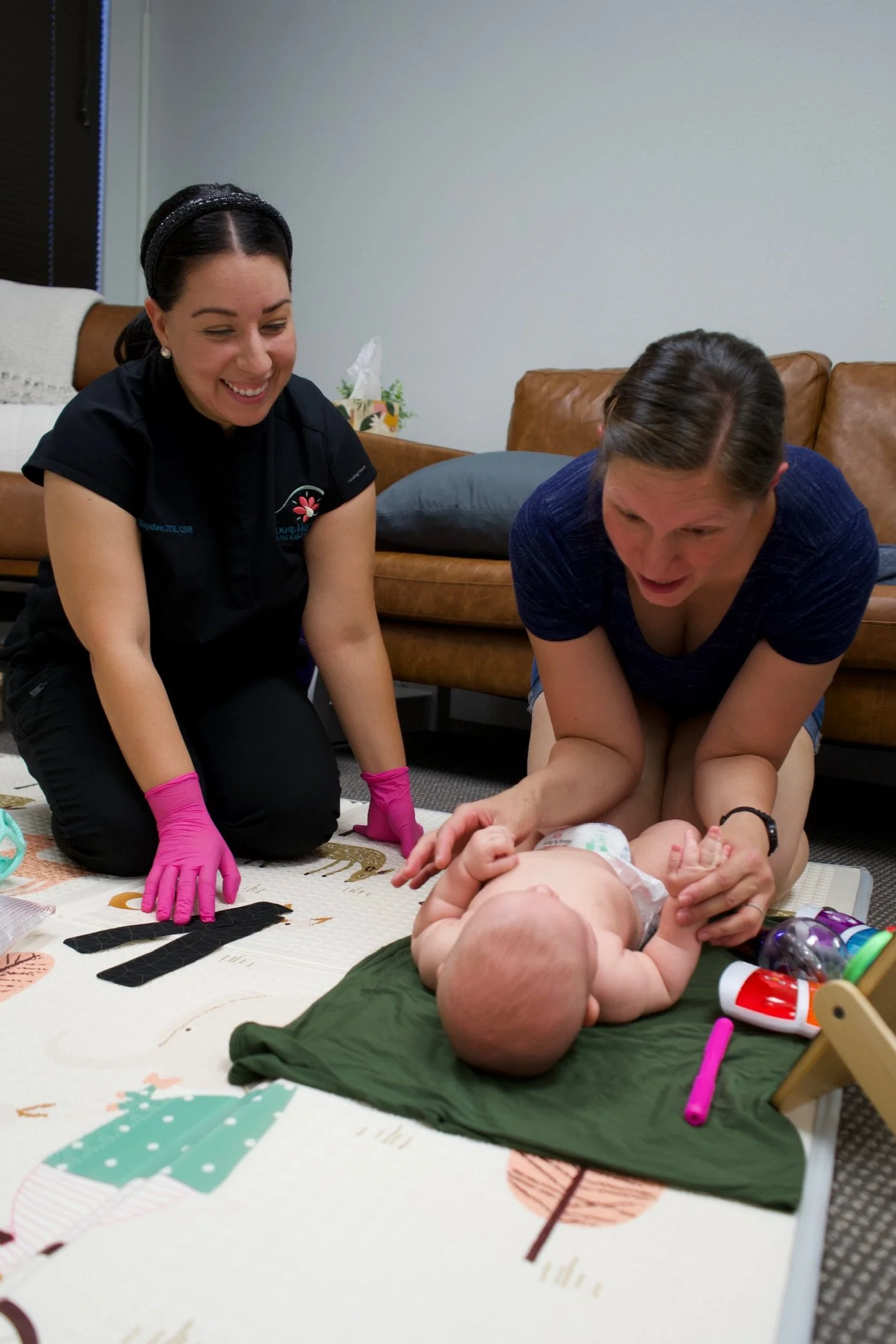 Haydee Medrano working with a mom and baby in her clinic Bloom Her Path she co-owns as an occupational therapist and Certified Breastfeeding Specialist in Corpus Christi, TX.
