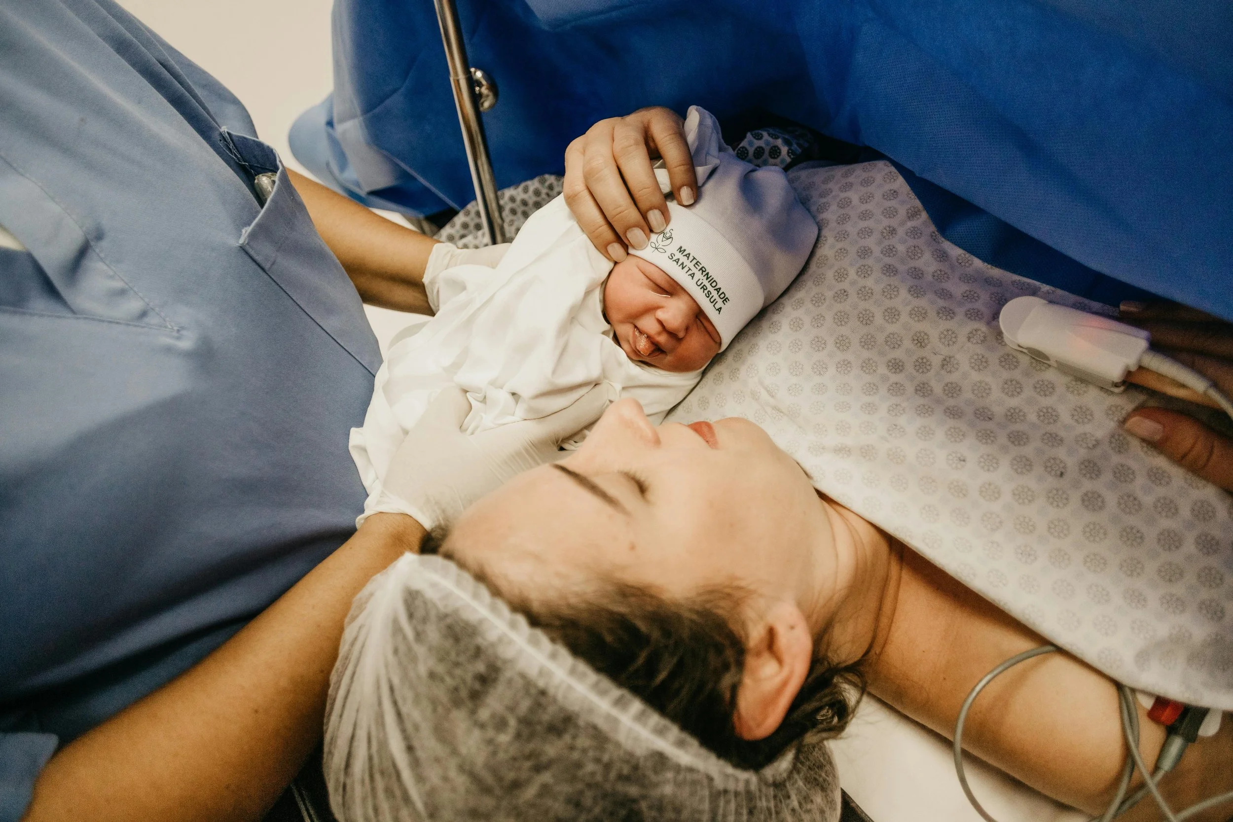 Mom and newborn right after cesarean birth in operating room. Bloom Her Path provides postpartum recovery occupational therapy services in Corpus Christi, TX for vaginal and cesarean births