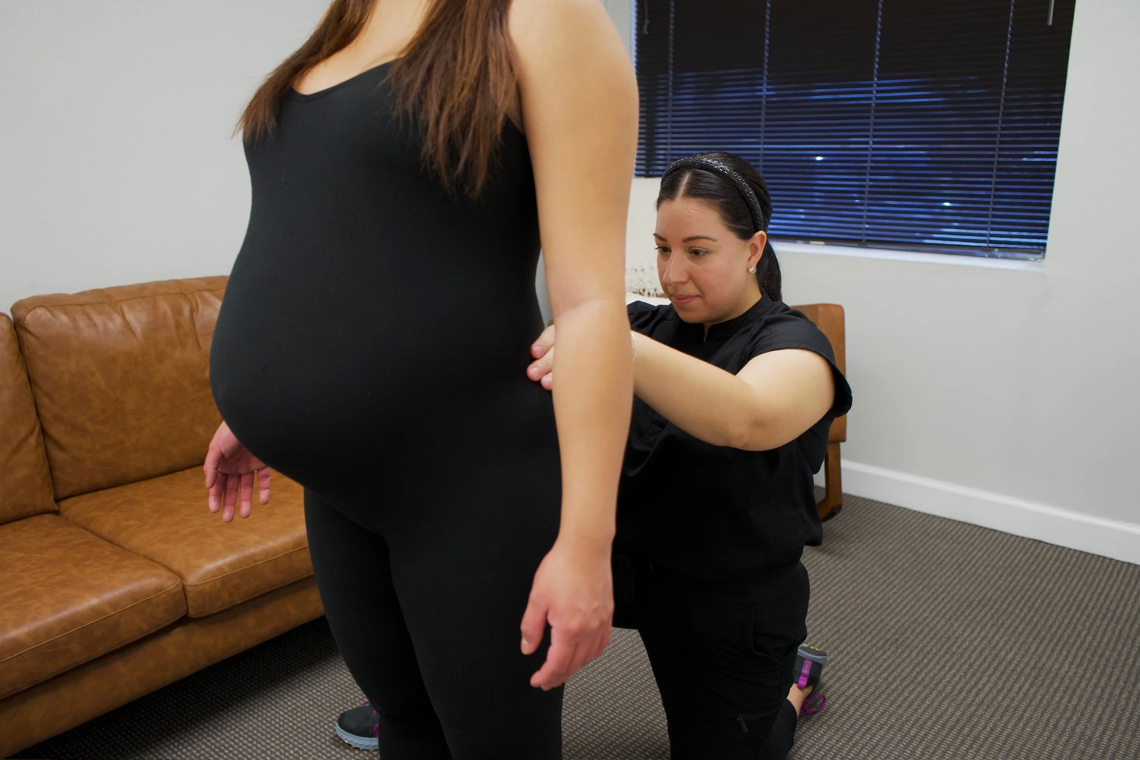 Haydee Medrano providing pelvic floor therapy assessment to a pregnant woman at Bloom Her Path in Corpus Christi, TX to treat back pain, pelvic pain, postural instability, and pregnancy aches