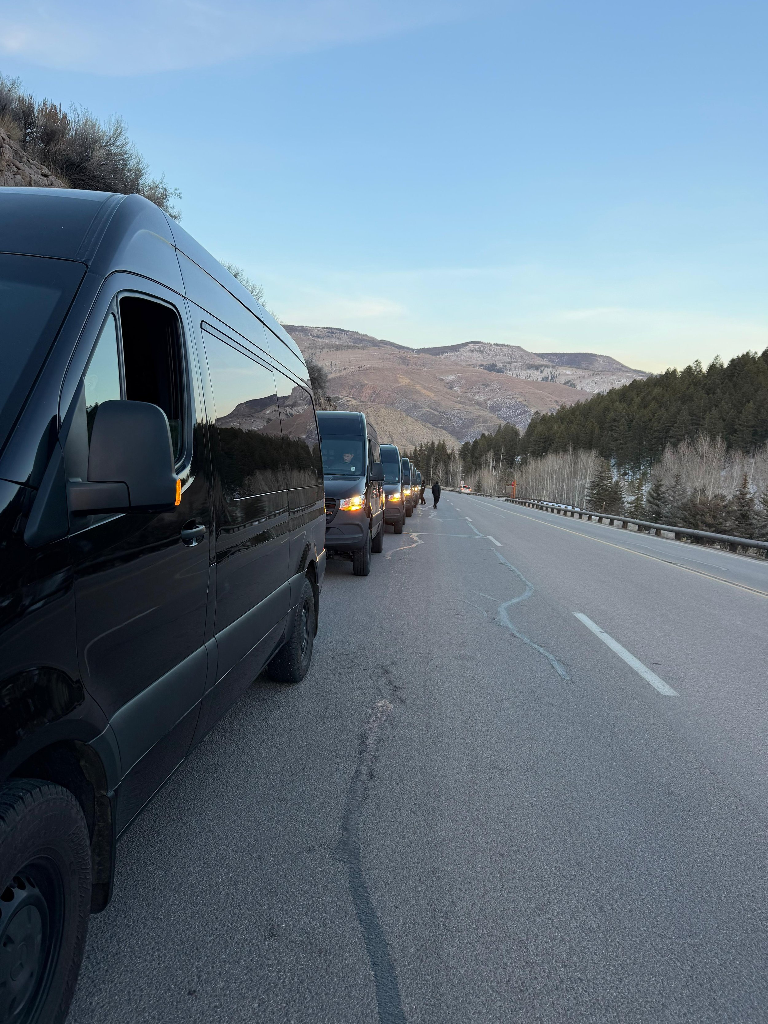 IZKAM black passenger vans providing group transportation in the Colorado mountains