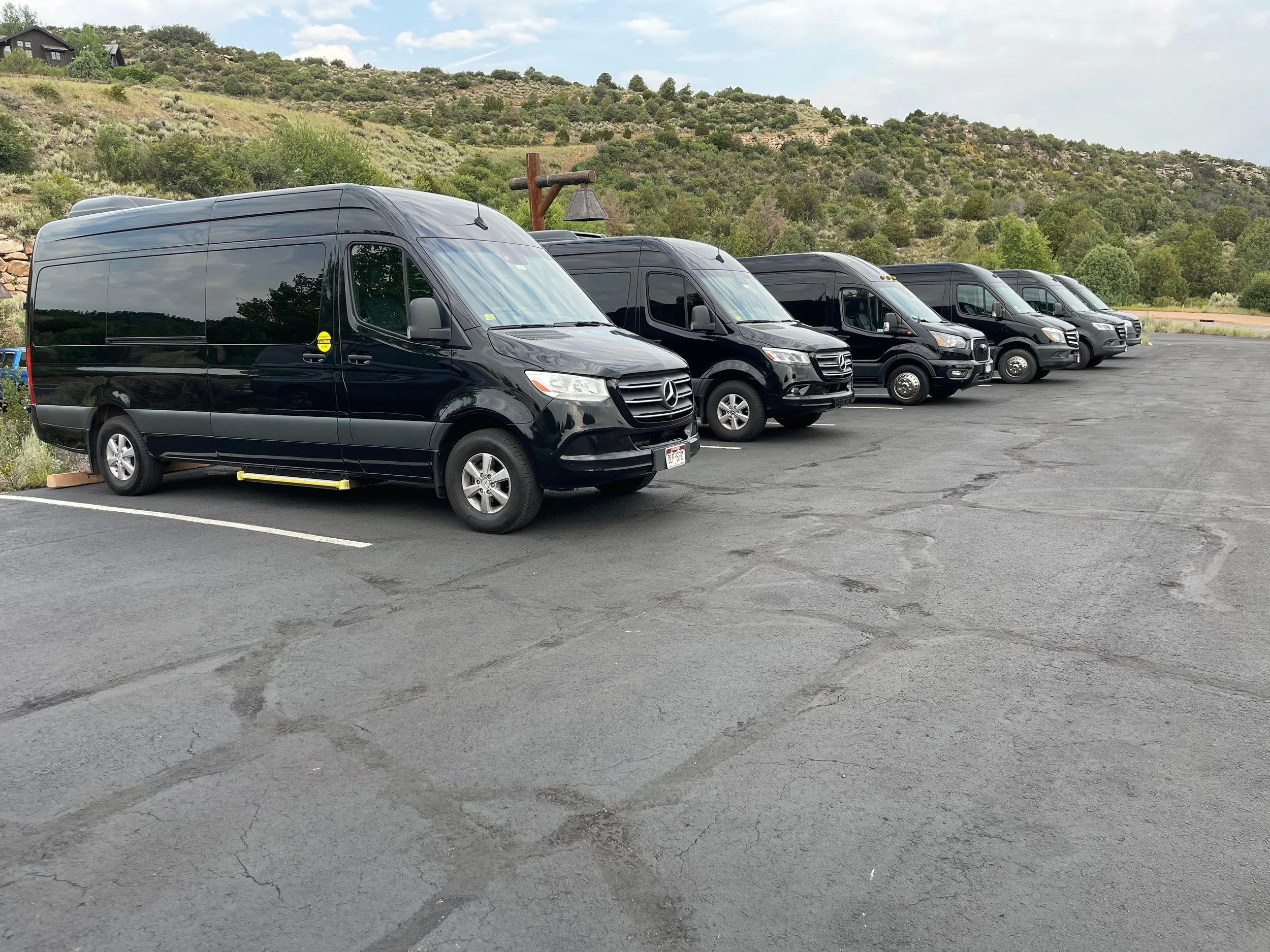 Fleet of black Mercedes passenger vans for private group transportation in Colorado