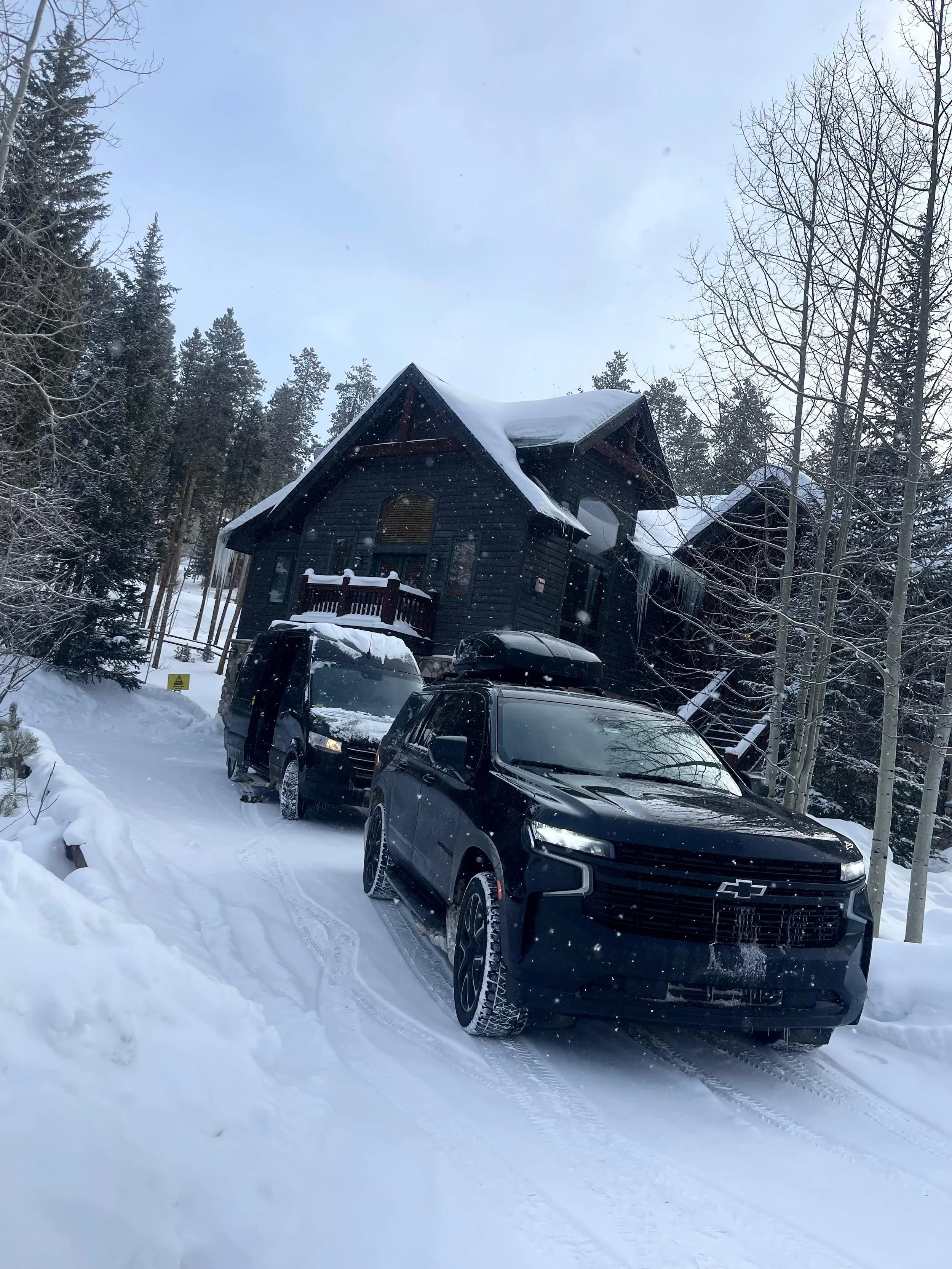 IZKAM black SUVs providing winter transportation at a Colorado mountain lodge