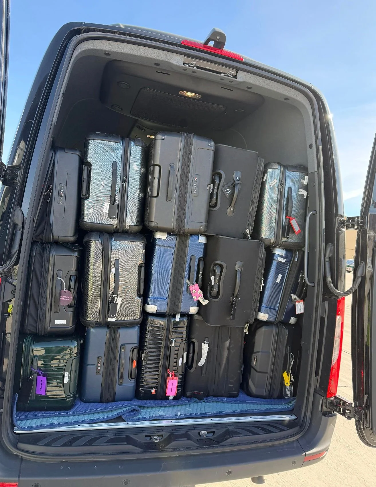 Passenger luggage securely loaded in an IZKAM airport transportation van