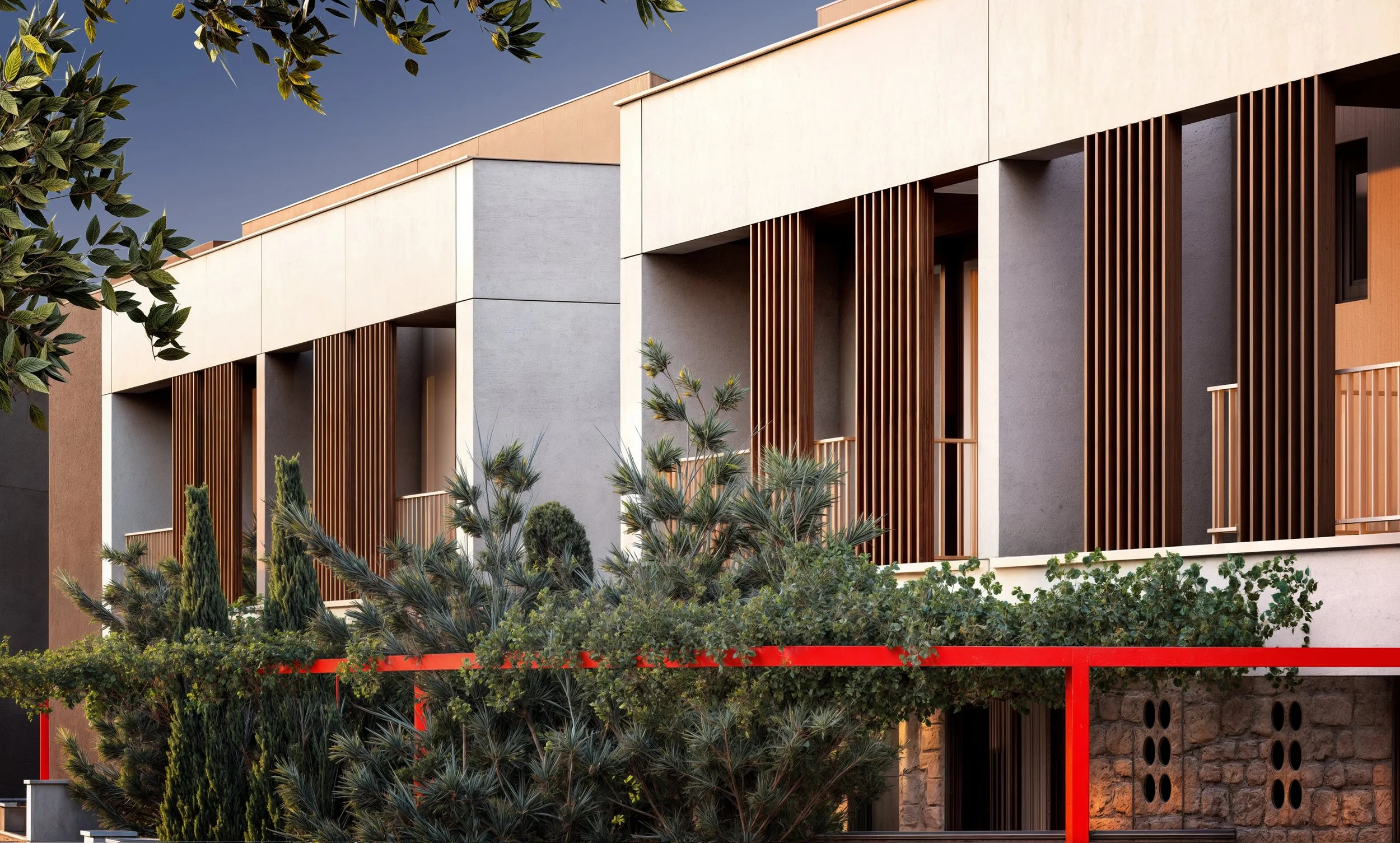 Modern building with beige and gray walls, wooden slats acting as window shades, and lush greenery in the foreground, including various bushes and trees.