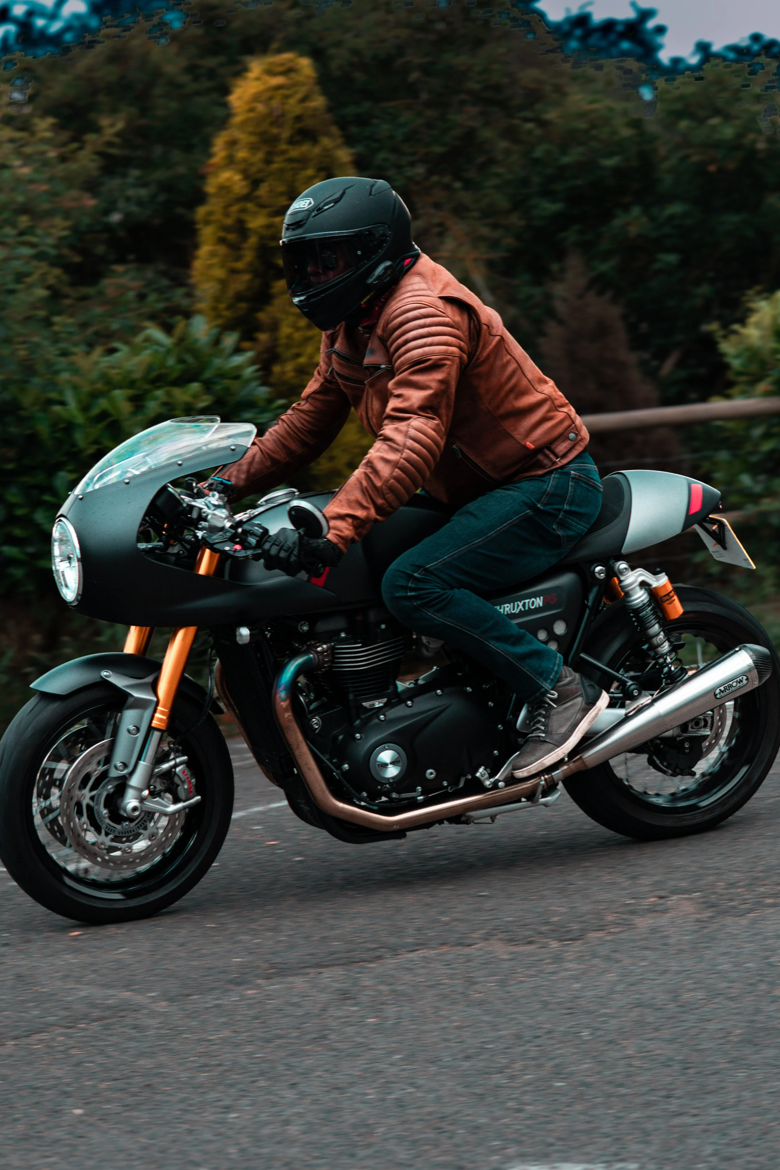 A beautiful triumph motorbike matching a classic brown leather motorbike jacket 
