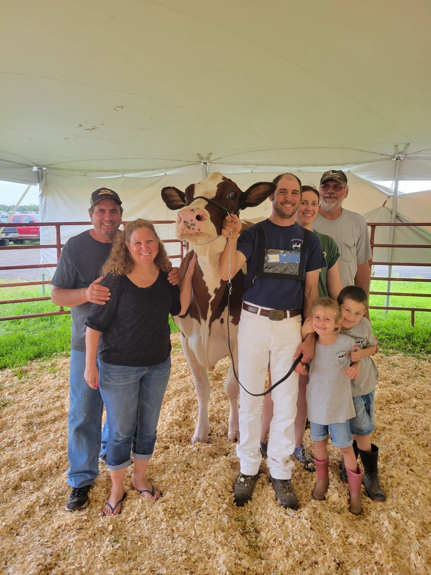 Four generations of the Puskas family proudly showcasing their dairy cows.