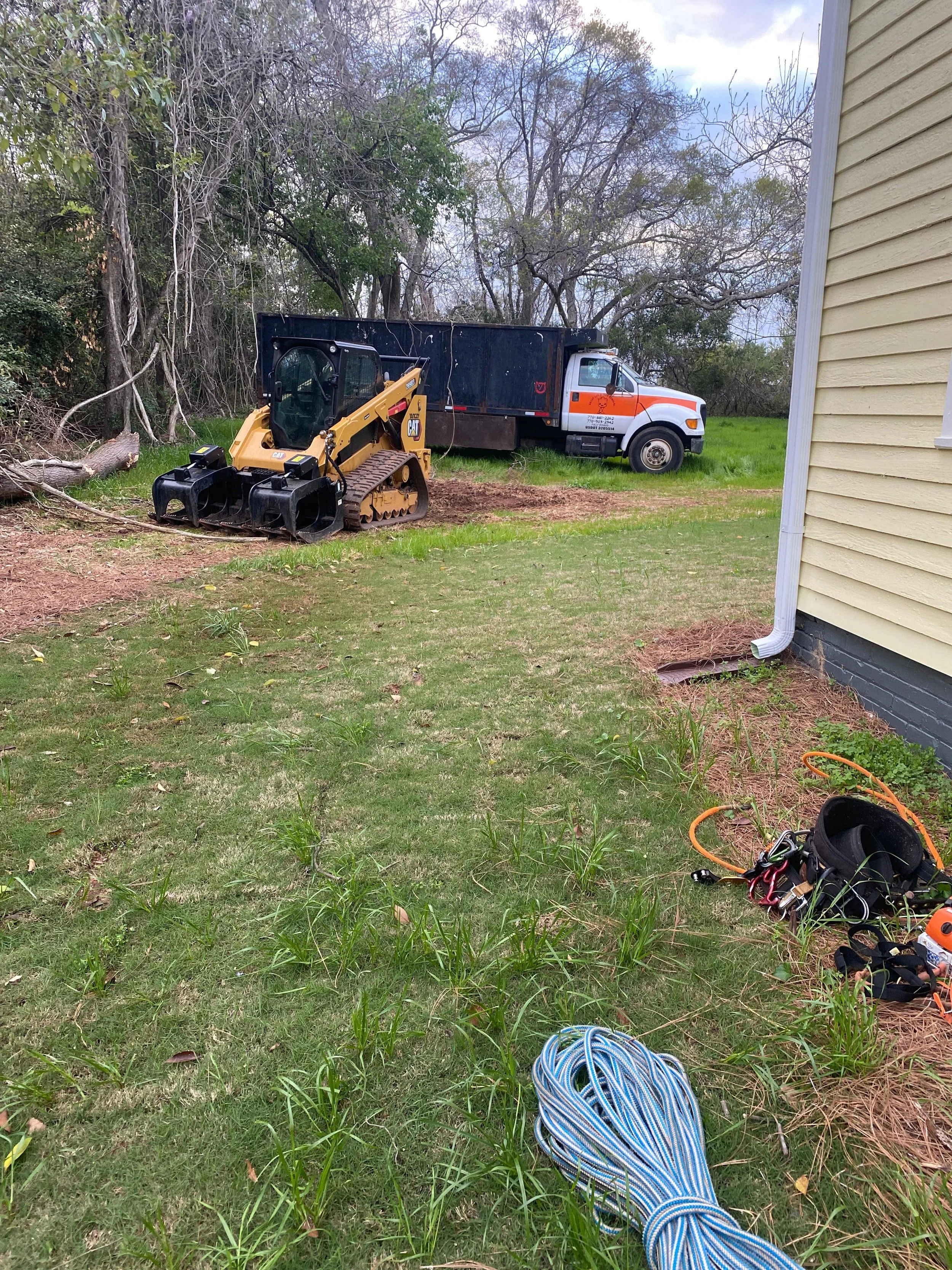 man cutting tree with saw