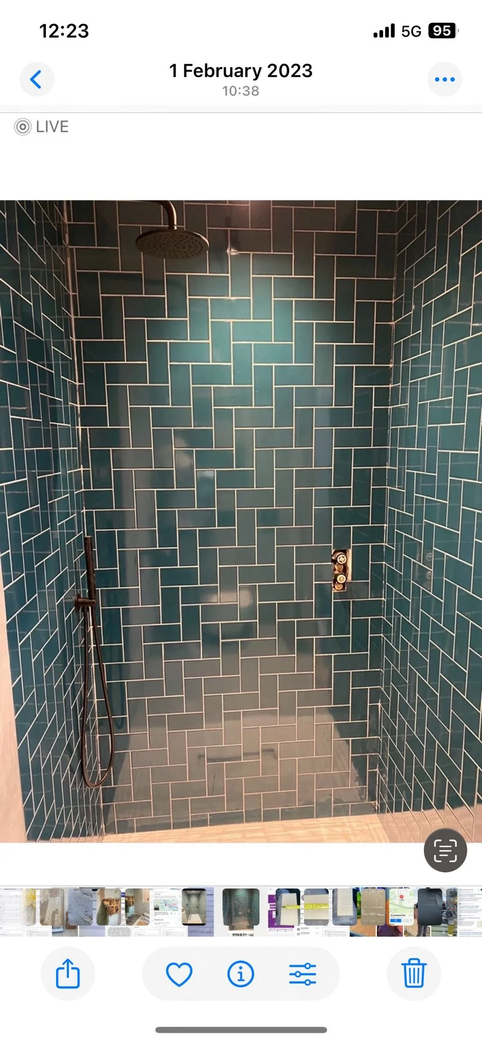 Modern walk-in shower with teal subway tiles, a rain shower head, and a handheld shower.