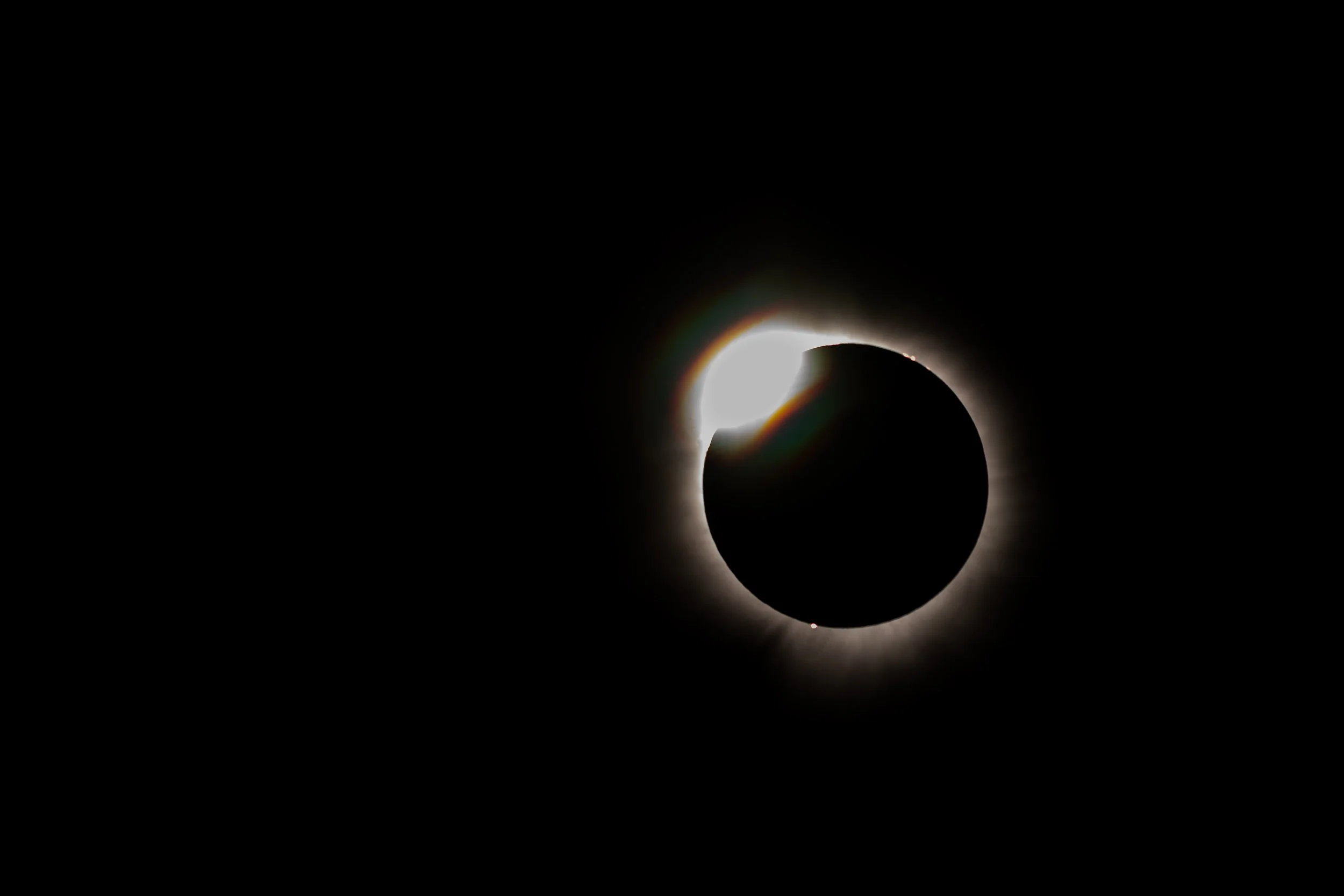 A solar eclipse where the moon covers most of the sun, leaving a bright ring around the dark moon.