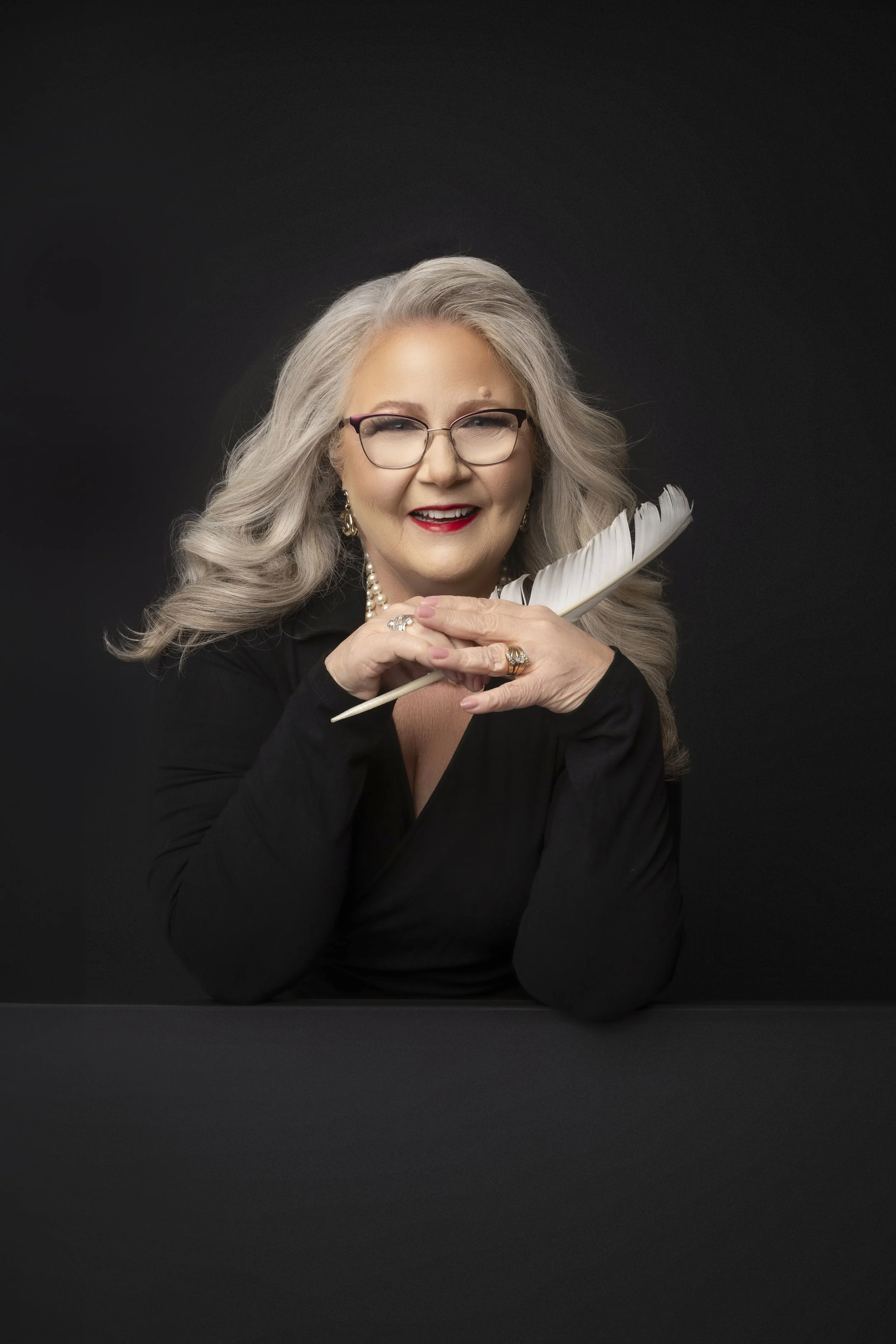 Woman entrepreneur during a professional branding session in a Las Vegas studio with dramatic lighting.