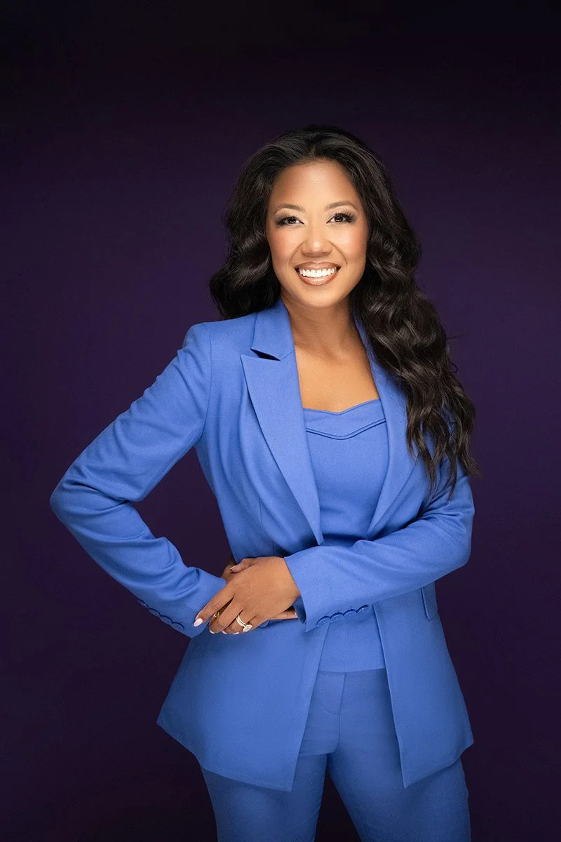 Woman entrepreneur during a studio branding session with dramatic lighting.