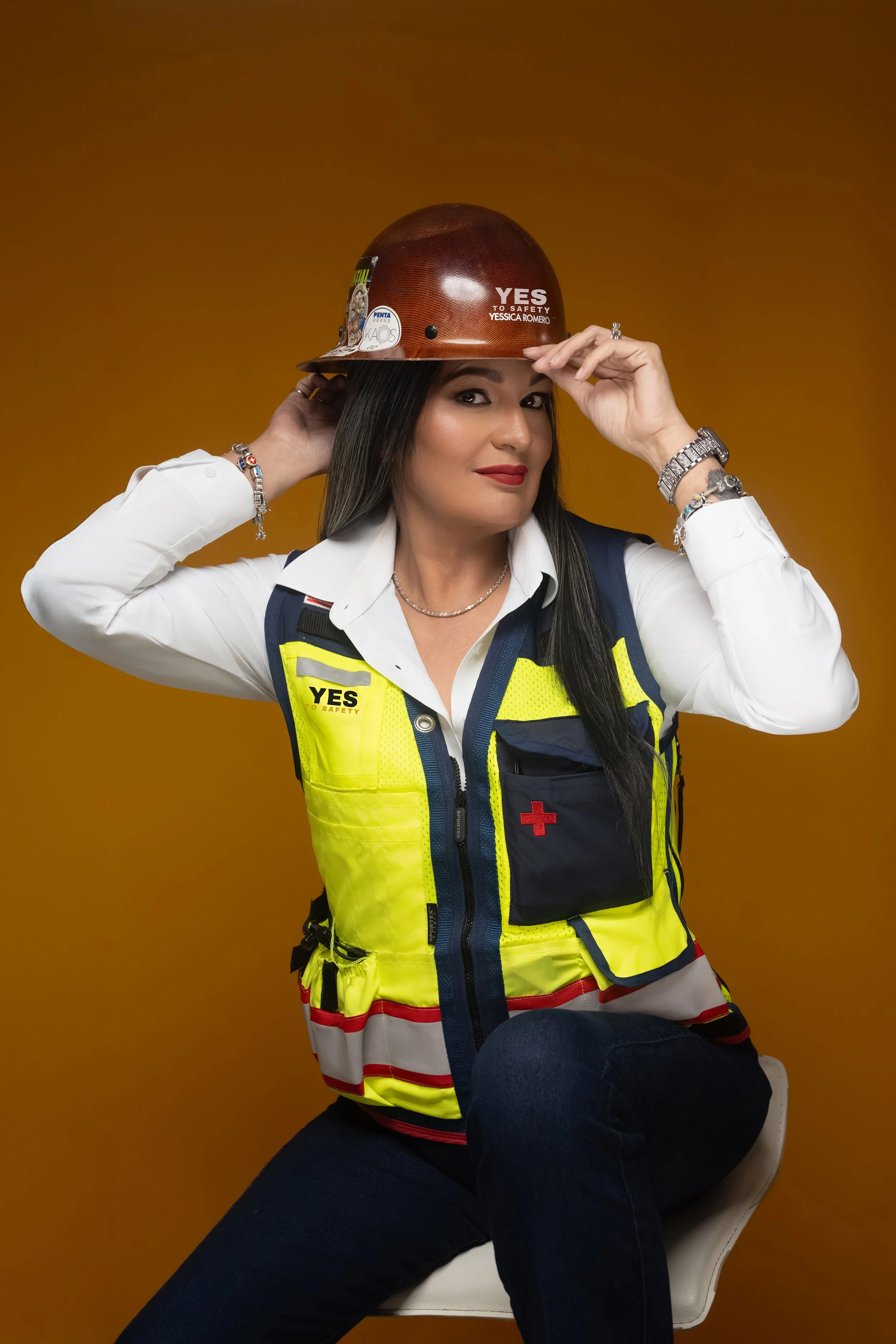 Latina entrepreneur posing in construction gear for She Means Business Magazine.