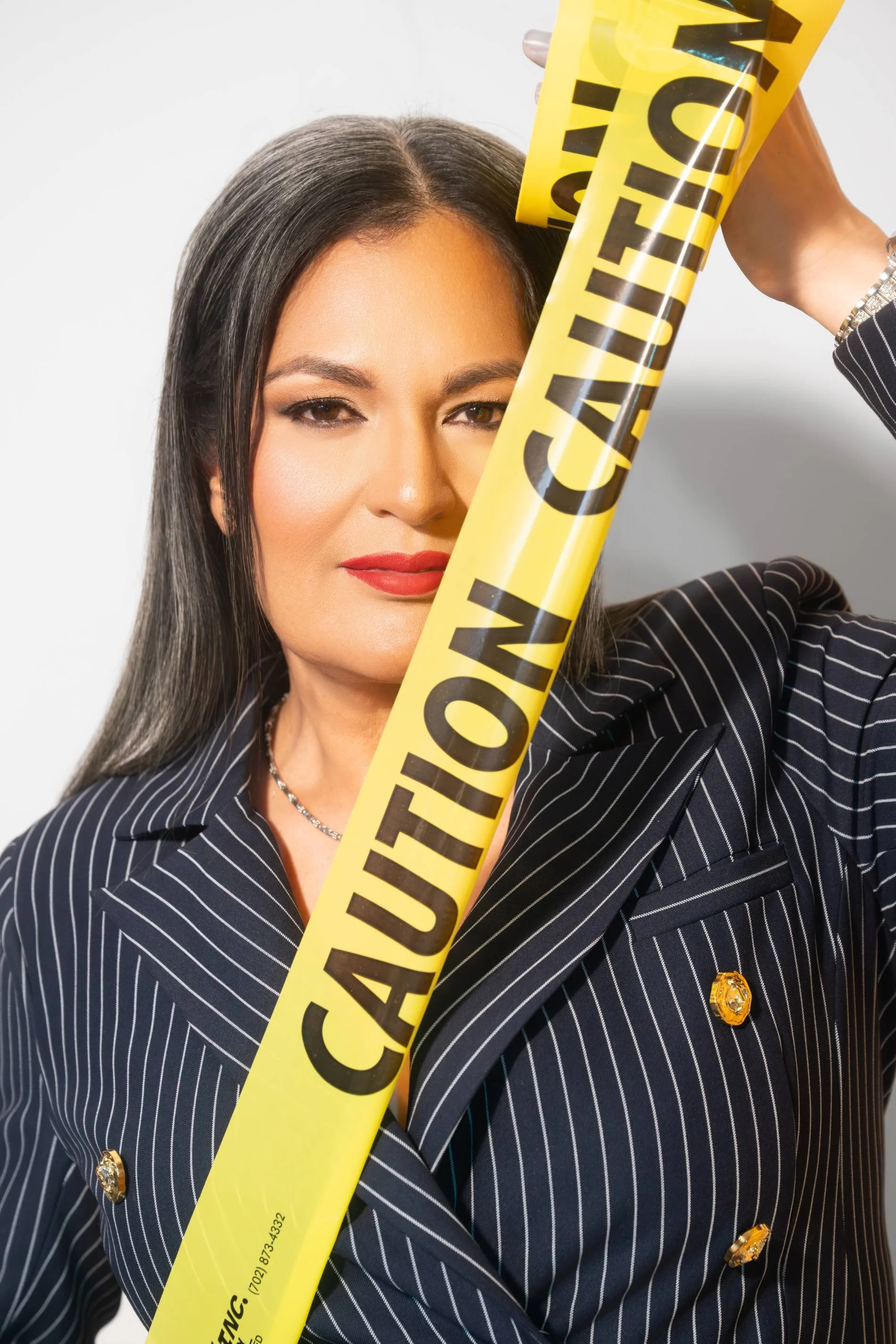 Female business owner during a professional branding session with dramatic studio light.